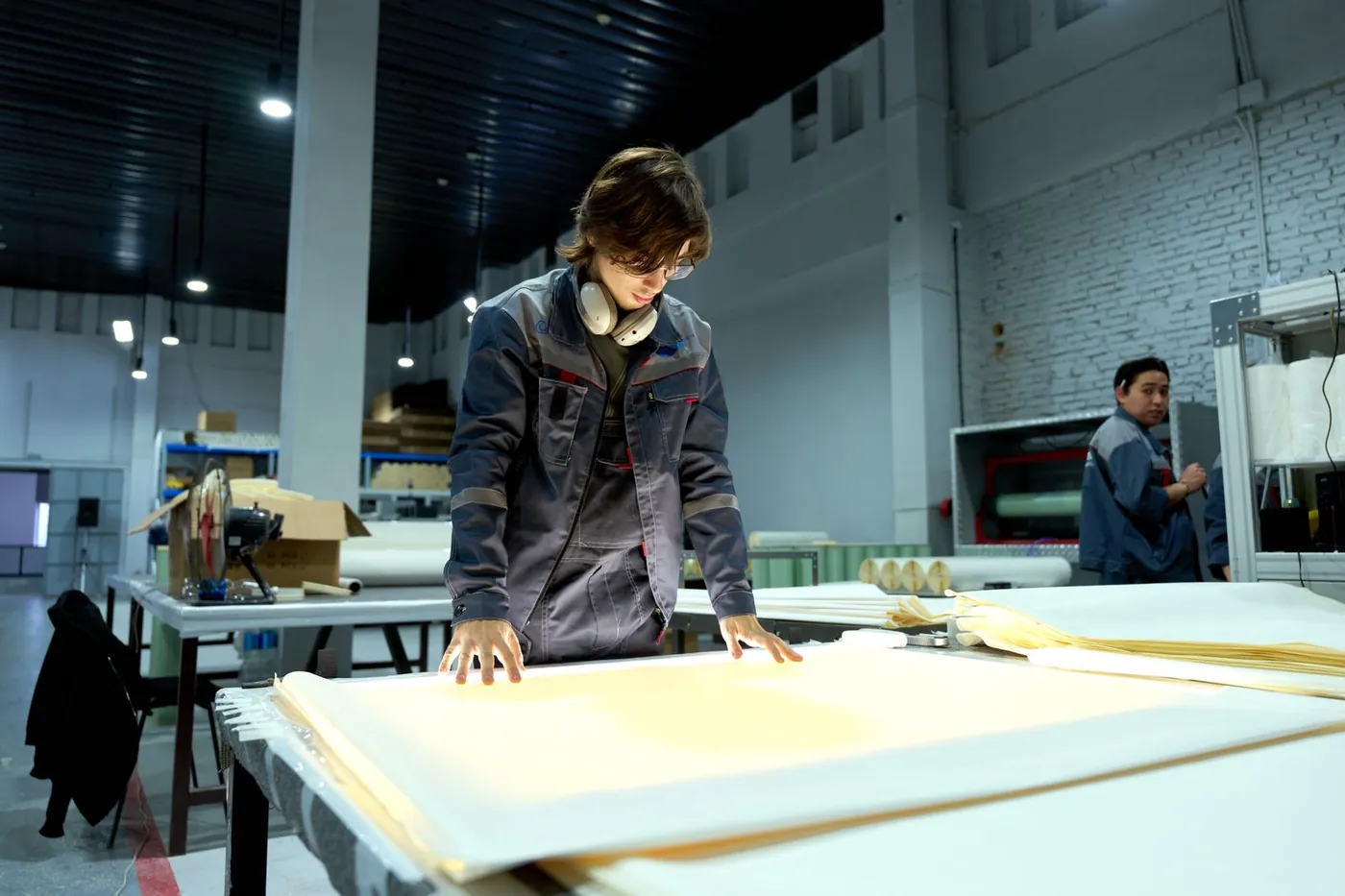 Worker inspecting materials in a factory